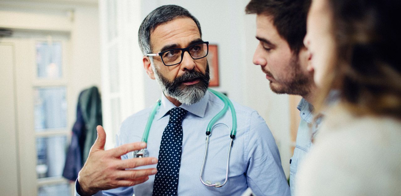 A doctor explains information to patients.